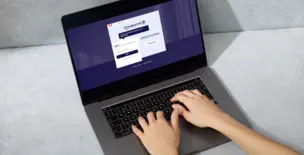 Hands typing on a laptop with Cloudpermit application on the screen